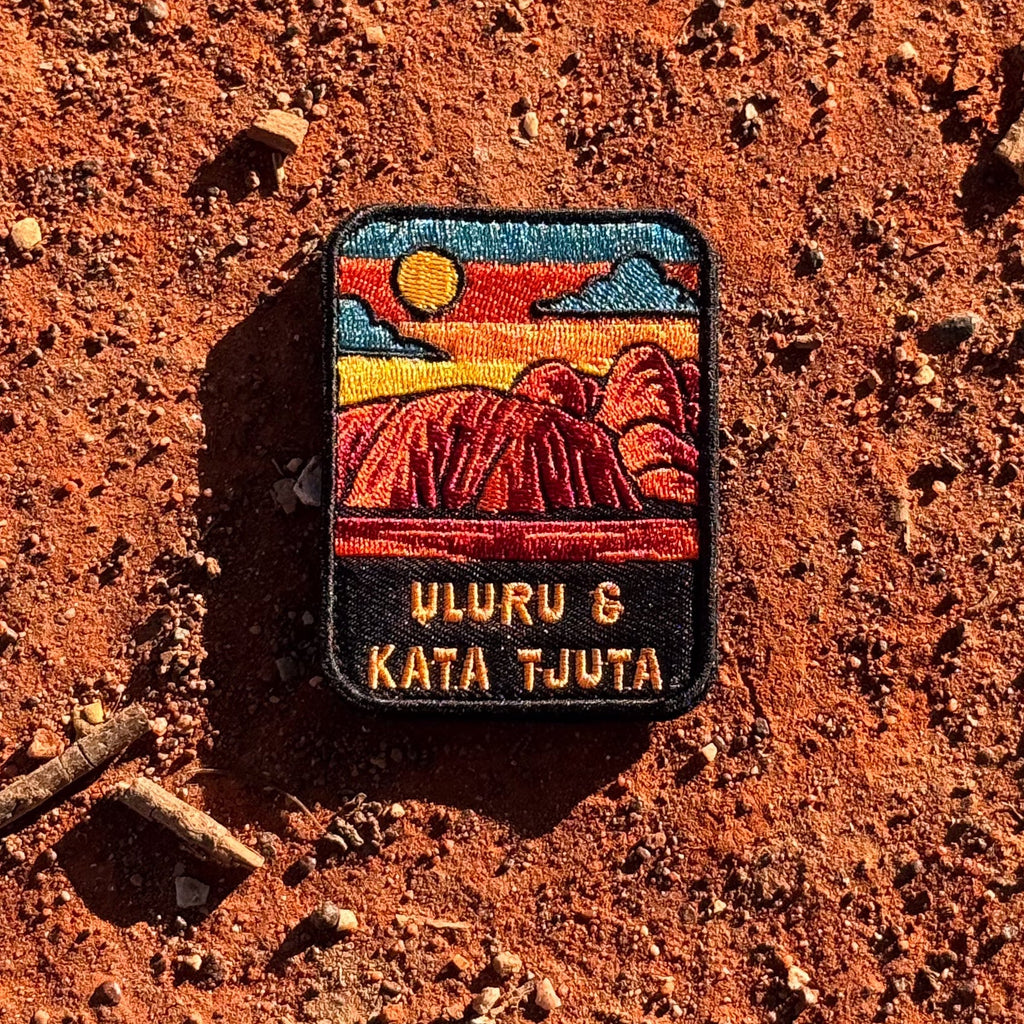 Uluru-Kata Tjuta embroidered travel patch with Uluru and Kata Tjuta rising from red desert country.