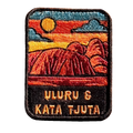 Uluru-Kata Tjuta embroidered travel patch with Uluru and Kata Tjuta rising from red desert country; photographed on a transparent background.