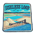 Useless Loop embroidered travel patch with salt flats and blue coastal water; photographed on a transparent background.
