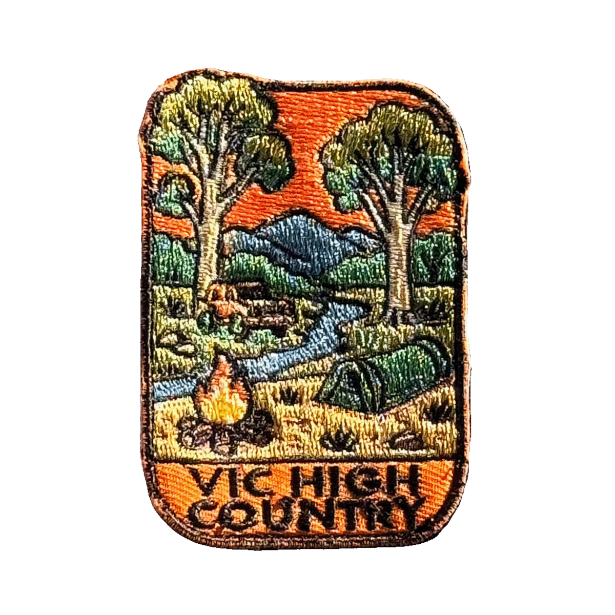 Victorian High Country embroidered travel patch with a four-wheel drive climbing a steep alpine dirt track; photographed on a transparent background.