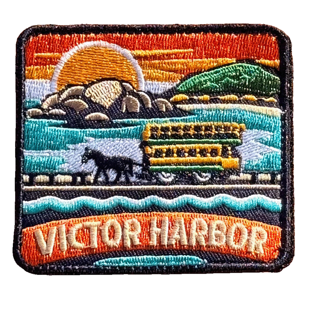 Victor Harbor embroidered travel patch with a horse-drawn tram travelling across the causeway; photographed on a transparent background.
