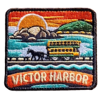Victor Harbor embroidered travel patch with a horse-drawn tram travelling across the causeway; photographed on a transparent background.
