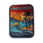 Whitsundays embroidered travel patch with a tropical island beach with palm trees, curling wave and sunset; photographed on a transparent background.