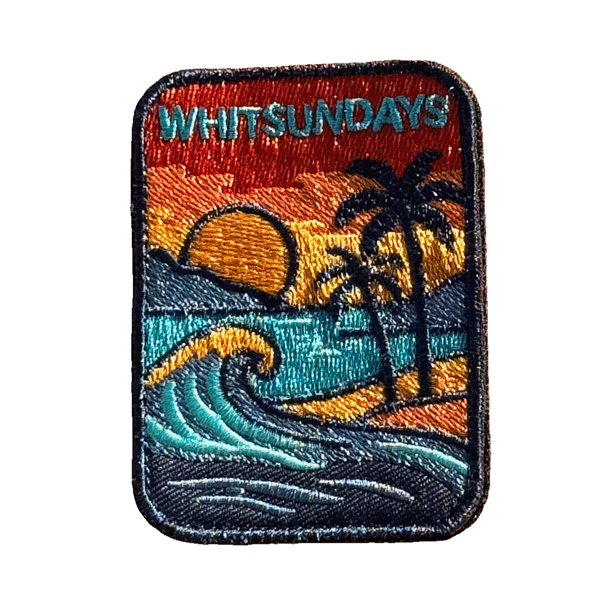 Whitsundays embroidered travel patch with a tropical island beach with palm trees, curling wave and sunset; photographed on a transparent background.