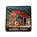 Woods Point embroidered travel patch with a rustic high-country petrol station with old fuel pumps among pine trees; photographed on a transparent background.